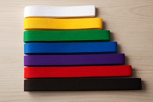 different colored karate belts lined up in varying lengths