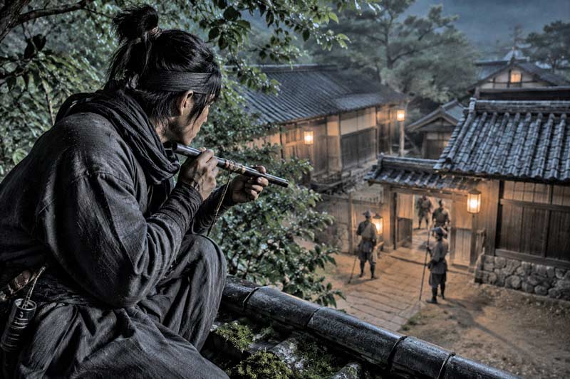 Feudal Japanese scout aiming a concealed blowgun from a rooftop at night