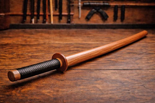 Traditional wooden bokken on a dojo floor